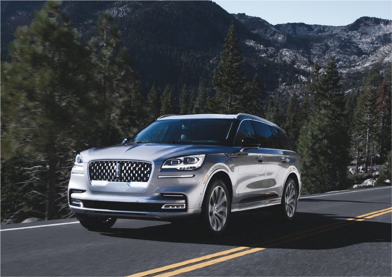 A 2023 Lincoln Aviator® Grand Touring SUV being driven on a winding road to demonstrate the capabilities of all-wheel drive | Duncan Lincoln in Blacksburg VA